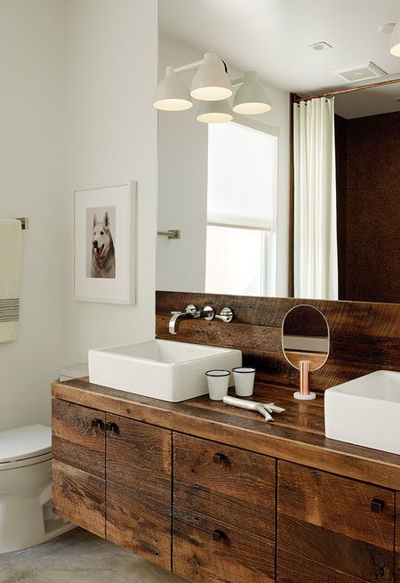 Builder Luke Gilligan of Gilligan Development used reclaimed oak planks from a deconstructed barn to create the bathroom’s millwork. To achieve the rugged look, he sanded and wire-brushed the wood, then applied a clear stain. The sinks are from Duravit’s Vero line and the cabinet pulls are from Top Knobs. Rustic Modern Bathroom, Victorian Home Renovation, Rustic Bathroom Vanities, Rustic Bathroom Designs, Bad Inspiration, Rustic Bathroom Decor, Rustic Bathrooms, Unique Bathroom, Bad Design