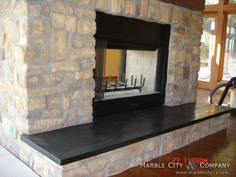 Fireplace with stone veneer and black granite hearth. Black Honed Granite, Granite Hearth, Grey Fireplace, Fireplaces Layout, Granite Fireplace, Black Brick Wall, Painted Brick Fireplaces, Fireplace Pictures, Stone Fireplace Surround