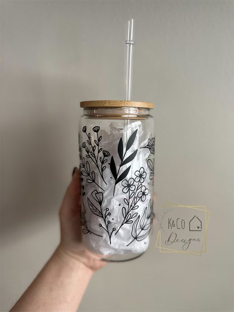 This glass cup is great for any cold beverage! Available in a 16 oz or 25 oz. cup, with your choice of white or black design. Your order includes the bamboo lid and reusable plastic straw. These bamboo lids have silicone seals around the lid and straw. Wood grain on the lid may vary in color. Designs are made with high quality permanent vinyl. Glass With Bamboo Lid And Straw, Grandparents Christmas Gifts, Beer Cup, Cute Coffee Cups, Halloween Door Mat, Glass Coffee Cups, Iced Coffee Cup, Custom Doormat, Co Design