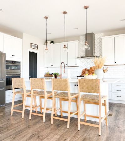 Have you been looking for the perfect boho bar stools for your kitchen island? Click the link to see my round up of all the best and budget friendly boho bar stools from Target, World Market and Walmart! These would also work well with farmhouse style! They are all neutral and perfect with all kitchen styles and colors! #whitekitchen #whitecabinets #whitecounters #subwaytile #whitesubwaytile #subwaytilebacksplash #copperkitchen #copperaccents #blackdoor #diningroom #kitchen Boho Bar Stools, Boho Coffee Bar, Woven Bar Stools, Boho Bar, Rattan Counter Stools, Rattan Stool, Kitchen Styles, Rattan Bar Stools, Bar Stools Kitchen Island