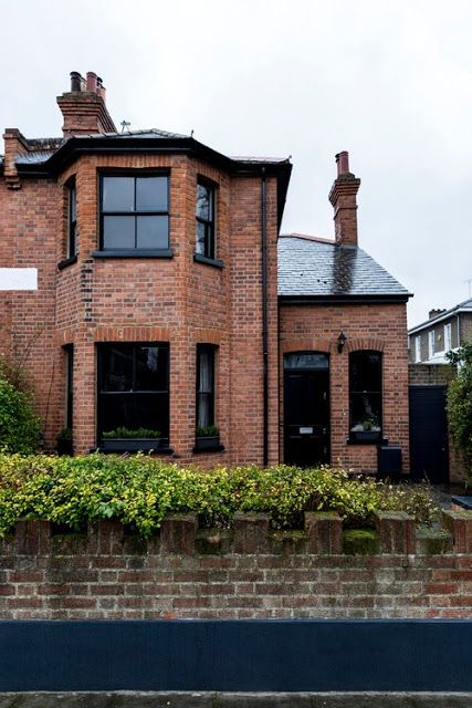 RED BRICK HOUSES WITH BLACK TRIM - design indulgence Brick House With Black Trim, House With Black Trim, Red Brick House Exterior, Red Brick Exteriors, Industrial Exterior, Brick House Exterior, Brick Homes, Brick Cottage, Brick Houses