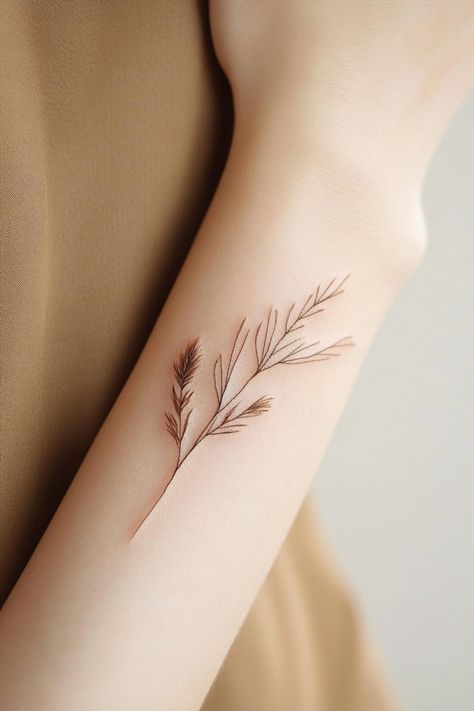 Delicate botanical tattoo on an arm featuring slender leaves and stems. Dainty Small Tattoos For Women, Brown Tattoos For Women, Tattoo Brown Ink, Light Brown Tattoo, Brown Ink Tattoos, Small Coverup Tattoo Ideas, Brown Ink Tattoo, Unique Small Tattoo Ideas, Brown Tattoos