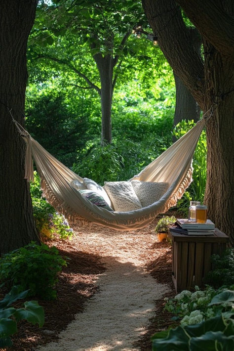 Breezy Hammock Havens create a laid-back, relaxing vibe for patio furniture inspo. Hammocks made from durable, weather-resistant fabric can be hung between trees, on stands, or incorporated into furniture designs. They are perfect for napping or lounging and come in a variety of colors and patterns. Add side tables for books and drinks to enhance the leisure experience. Swing into relaxation with stylish hammock ideas—click here for inspiration! Hammock Setup Backyard, 2 Hammock Ideas Backyard, Backyard Hammock Ideas No Tree, Hammock Between Trees, Hammock Between Two Trees, Mediterranean Terrace, Stylish Outdoor Furniture, Balcony Furniture, Coastal Retreat