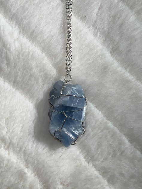 Sometimes you just want to carry your favourite type of crystal with you at all times. That is why CSKY brings you a handmade, wired blue calcite pendant necklace.  This type of wiring is unique, working with the natural shape of each crystal to bring the best out of it. Our crystals are ethically sourced natural beauties.  Blue calcite is a strong emotional cleanser and aura protector, especially when carried with you. Just like its pale blue colour, it provides a sense of peace and calmness, w Calcite Necklace, Blue Calcite Crystal, Blue Stone Pendant, Blue Aura, Blue Crystal Necklace, Raw Crystal Necklace, Aura Crystals, Types Of Crystals, Blue Calcite