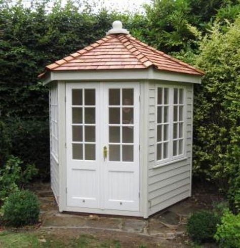 Wiveton Summerhouse With Cedar Shingles This hexagonal summerhouse is positioned beautifully in this Herefordshire garden. The combination of the Valtti paint systems, both Sandstone and Ivory, compliment the greenery of the surrounding hedge, as well as looking stunning with the Cedar Shingles. Summer House Plans, Hexagonal Summerhouse, Hexagon Garden, Japanese Shrine, Summer Houses, Cedar Shingles, Garden Whimsy, Garden Sheds, She Sheds