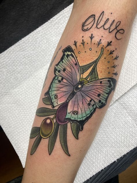 Neo traditional, color butterfly with olive branch and halo tattoo. This butterfly is iridescent looking contrasted by green, earthy olive branch and yellow halo. Tattoo made by Charlotte Timmons at Grit N Glory in NYC. Glory Tattoo, Halo Tattoo, Neo Traditional, By Charlotte, Olive Branch, Tattoo Styles, Butterfly Tattoo, Tattoo Studio, Traditional Style