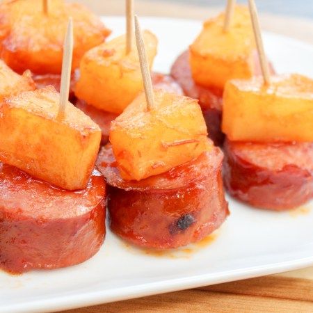 Glazed Smoked Sausage and Pineapple Bites Are The Perfect Quick Appetizer To Entertain Holiday Guests Or To Enjoy While Watching Your Favorite Team! #easyappetizers #smokedsausagerecips #tailgatingfood #holidayappetizers Smoked Sausage And Pineapple, Hawaiian Kielbasa, Sausage And Pineapple, Pineapple Appetizers, Horderves Appetizers, Sausage Appetizers, Quick Appetizer, Superbowl Appetizers, Tropical Food