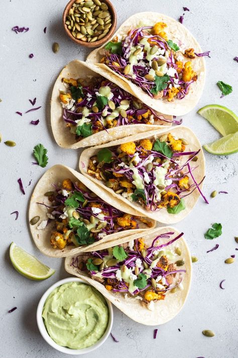 Roasted Cauliflower Tacos with Avocado Crema | Roasted Cauliflower Tacos with Avocado Crema – made with roasted cauliflower, purple cabbage, lime juice, pinto beans and avocado crema. A vegetarian take on Taco Tuesday! | The Crooked Carrot Roasted Red Cabbage, Roasted Cauliflower Tacos, Corn Tortilla Recipes, Tacos With Avocado, A Balanced Meal, Red Cabbage Slaw, Homemade Corn Tortillas, Cauliflower Tacos, Avocado Crema