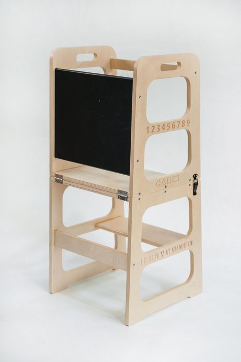 Montessori learning tower is a versatile and educational piece of furniture designed to support a toddler's independence, creativity, and learning. The combination of a stool, table, and chair, along with educational elements like a blackboard with numbers and alphabets, makes it a comprehensive learning tower. The foldable feature enhances its practicality for families with space considerations.  Key BENEFITS: ✔️ Improves problem-solving skills ✔️ Encourages open-ended play ✔️ Boosts self-confi Toddler Kitchen Stool, Helper Tower, Independent Toddler, Toddler Kitchen, Stool Table, Daily Chores, Montessori Learning, Montessori Furniture, Kitchen Stool