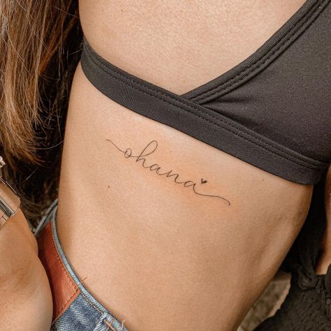 Name Tattoo Danty, Ohana Rib Tattoo, Ohana Script Tattoo, Ohana Tattoo With Flower, Ohana Tattoos, Ohana Tattoo Ideas, Ohana Tattoo, Wrist Tattoo Ideas, Magic Runes