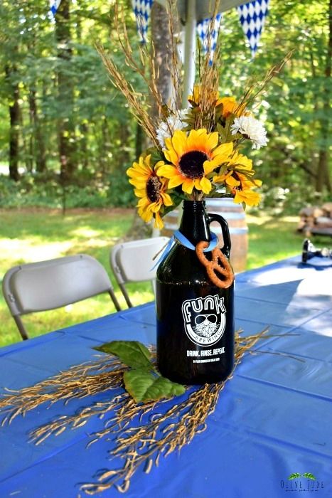 DIY: Oktoberfest Biergarten Growler Centerpieces | Olive Jude Oktoberfest Table Decorations, Oktoberfest Party Outfit, Easy Flower Decorations, Growler Centerpiece, Oktoberfest Centerpieces, Oktoberfest Crafts, Diy Oktoberfest, Flower Decorations Ideas, Diy Flower Centerpieces