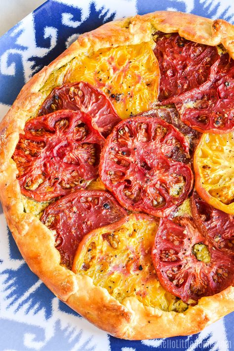 Looking for Tomato Recipe Ideas? You’ll love this scrumptious Tomato Galette recipe! Learn how to make the BEST Tomato Galette using simple ingredients: fresh tomatoes, pesto, cream cheese, lemon, and pie crust. This savory Rustic Tomato Tart is the easy to make, and the perfect way to use Heirloom Tomatoes (or summer tomatoes from your garden or farmers market). Treat yourself to this homemade Vegetarian Galette today … you’ll love the Tart’s delicious Tomato Basil Flavor! | Hello L... Vegetarian Galette, Veggie Recipes Breakfast, Rustic Tomato Tart, Pesto Cream Cheese, Savory Galette, Galette Recipes, Tomato Galette, Tomato Tart Recipe, Tomato Recipe