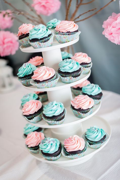 Cupcake towerChocolate cupcakes with blue and pink frosting. Pink And Blue Food Ideas, Gender Reveal Cupcake Ideas Pink Blue, Blue And Pink Desserts, Gender Reveal Cake And Cupcakes, Pink And Blue Cupcakes Gender Reveal, Cupcake Gender Reveal Ideas, Gender Reveal Cupcakes Pink And Blue, Gender Reveal Dessert Table Ideas, Pink And Blue Food