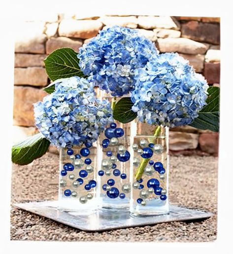 PRICES MAY VARY. Transform ordinary vases into EXTRAordinary centerpieces with these Eye-catching vase decorations. Great for wedding centerpieces, Hanukkah, mitzvahs, graduations, bridal showers, birthdays, gifts, and much more... Fills 4 gallons of 250 Floating Pearls and the most Transparent Gels for your vases! Contains:100 Blue Pearls and 80 Silver Pearls all with no holes and shiny, 16 Jumbo 30mm (1 1/4"), 32 Large 20mm (3/4"), and 132 medium (14mm/0.5") + 4 Packets of the most Transparent Navy Blue Vase Decor, Floating Centerpieces, Vase Decorations, Blue Themed Wedding, Vase Fillers, Fairy String Lights, Floating Candles, Blue Pearl, Centerpiece Decorations