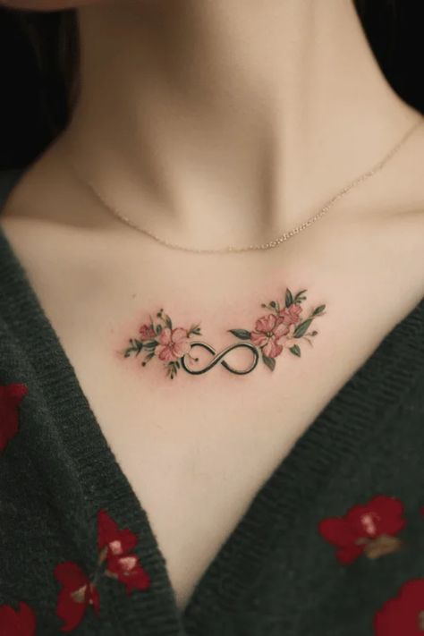 Infinity symbol tattoo with flowers on a person's upper chest. Feather Rib Tattoos, Cute Little Tattoos For Women, Dainty Back Tattoos, Small Dainty Tattoo, Little Tattoos For Women, Cute Dainty Tattoos, Dainty Tattoo Designs, Butterfly Foot Tattoo, Small Dainty Tattoos