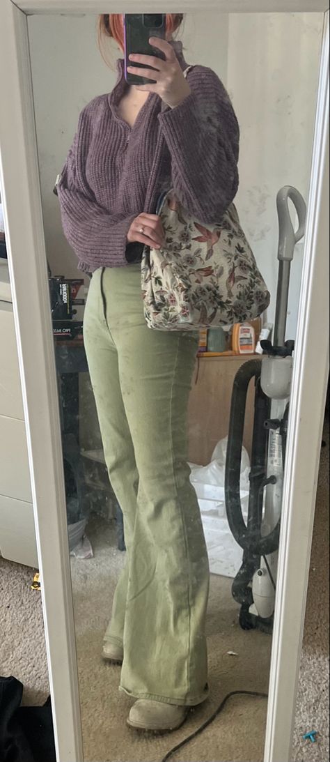 Green flare jeans, purple sweater, timberland boots, and vintage upholstery purse Light Green Flare Pants Outfit, Green Bootcut Pants Outfit, Olive Flare Pants Outfit, Lavender And Olive Green Outfit, Purple Green Outfit Aesthetic, Green Flares Outfit, Green Flare Jeans Outfit, Green Flared Pants Outfit, Green And Purple Outfit Aesthetic