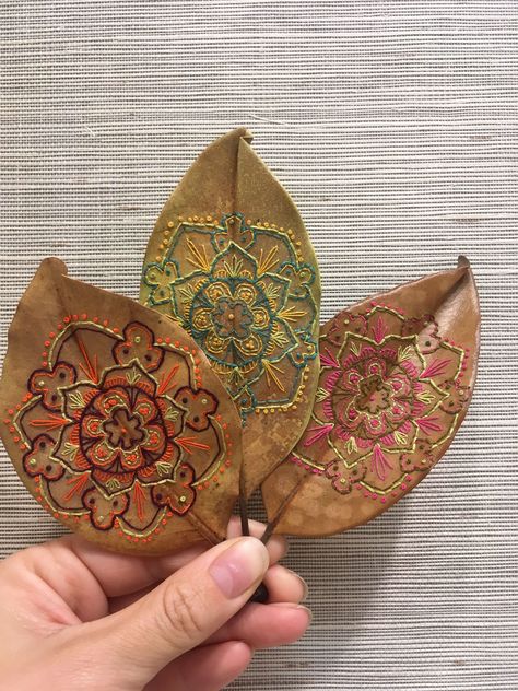 This is an on going collection of hand embroidered magnolia leaves. All of the illustrations for the embroideries are mine, all the leaves are real, and are handled carefully and preserved to last. This is something that I explored back in 2012, and began… Embroided Leaves, Leaf Stiching, Embroidered Magnolia, Autumn Garland, Embroidery Leaf, Leaves Art, Deco Nature, Embroidered Leaves, Leaf Crafts