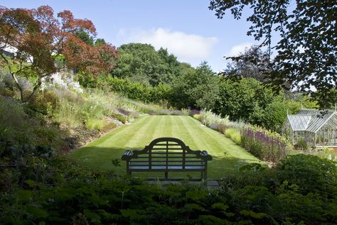 Acres Wild Garden Design. The precipitous levels in this previously inaccessible sloping garden have been rationalised to create a series of flat, usable spaces linked by winding paths and flights of steps.  To manage costs, reduce the environmental impact and generally soften the whole effect, the resultant banks have been planted rather than retained with expensive walls. Wild Garden Design, 86 Wallpaper, Barn Extension, Acres Wild, British Gardens, Sloping Garden, Wild Gardens, Country Garden Design, Small Front Gardens