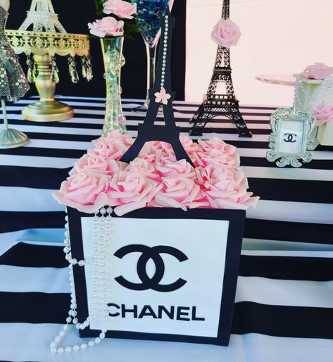 Great idea for a beautiful and elegant centerpiece #chanelpartytheme #cocochanel #birthdayparty Chanel Centerpiece Ideas, Chanel Centerpieces, Paris Centerpiece Ideas, Fashionista Birthday Party, 55th Birthday Party Ideas, Chanel Birthday Party Decoration, Chanel Bridal Shower, Chanel Baby Shower, Wedding Decorations Diy Centerpiece