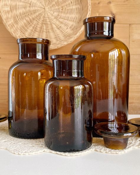 AVAILABLE Set of 3 vintage amber glass apothecary jars with lids, in great condition with no chips or cracks, maker’s mark and batch number noted on the bottom of each jar and seam lines noted on each side, small: 2.75x5.5”, medium: 3.75x6.5”, large: 4x8.25” 🏷️$40 . . . . . #vintage #amberglass #vintageamberglass #amberglassbottles #apothecary #apothecaryjars #apothecarybottles #vintageapothecary #antiqueapothecary #vintagebottles #vintagejars #vintagedecor #vintagevignette #vintagevibes #vi... Vintage Vignettes, Glass Apothecary Jars, Apothecary Bottles, Amber Glass Bottles, Vintage Jars, Maker’s Mark, Vintage Bottles, Apothecary Jars, Colour Tint