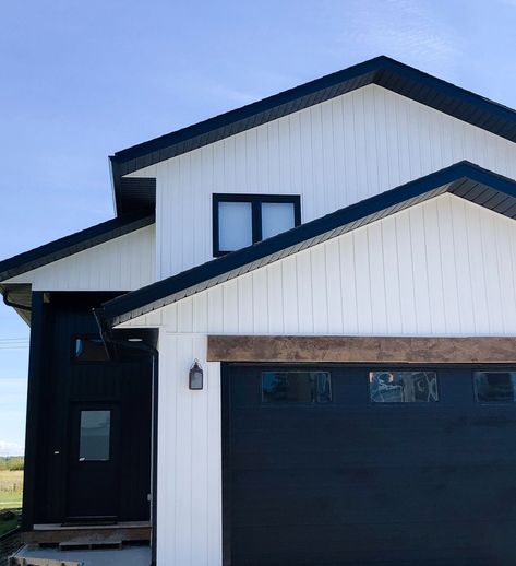 White House Black Garage Door, Black Metal Siding, Farmhouse Siding, White And Black Exterior, Black Garage Door, White Garage Doors, Painted Exterior Doors, House Accents, Black Garage