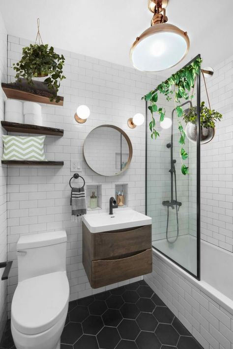 A windowless bathroom with white walls and a black floor. Details are wooden, and there is a round mirror above the sink. There are plant stickers added to look as if they are part of the photo. Tiny Bathroom No Window Ideas, Tiny Bathroom No Window, Small Bathroom Ideas With No Window, Windowless Bathroom Design, Low Maintenance Bathroom, Small Bathroom Ideas No Window, Small Windowless Bathroom Ideas, Small Bathroom No Window Ideas, Bathroom No Window Ideas