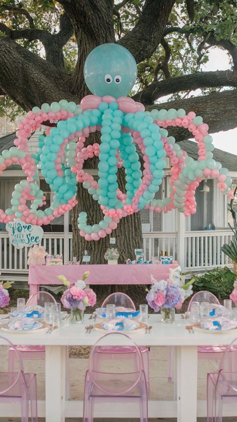 Under the Sea" themed first birthday setup with a large octopus balloon decoration and pastel table settings Ocean Theme Birthday Party Girl, Under Water Birthday Theme For Kids, Aquatic Theme Birthday Party, Octopus Themed Birthday Party, One Der The Sea First Birthday Boy, One Der The Sea First Birthday Girl, Under The Sea 1st Birthday Girl, Under The Sea Birthday Party Girl, Under The Sea First Birthday Girl