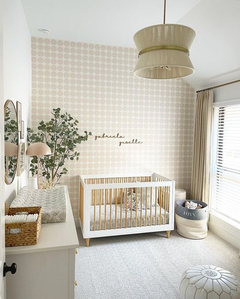 This cream-hued haven pairs a neutral palette with playful touches: polka dot wallpaper, a fun light fixture, and the Lolly Crib in White / Natural. 🪴 📸: @martincasaandchaos on Instagram Gender Neutral Wallpaper Nursery, Gender Neutral Wallpaper, Accent Wall Nursery, Nursery Wallpaper Accent Wall, Traditional Nursery Decor, Nursery Bedroom Ideas, Beige Nursery, Gender Neutral Baby Nursery, Nursery Accent Wall