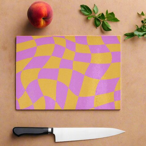 90s style Pink and Yellow Peach colourful check wavy chopping board, the vibrant throwback design will bring a smile to your face while the durable glass surface offers food safe protection for your worktops. This fun piece can protect your surface and can also be used on the table to protect against hot items, its even suitable to serve food on. If you love the 90s and colour this is the board for you. You can shop the matching coasters. High quality, tempered (shatterproof) glass that's hygienic and easy to clean Incredibly durable making it easy to use ever day. Doubles as a serving platter, perfect for gatherings and parties. Made to order in the U.K with high quality materials. Technical Material: Smooth, toughened glass Easy to clean - Dishwasher safe 4 non-slip PVC feet, Hand-printe