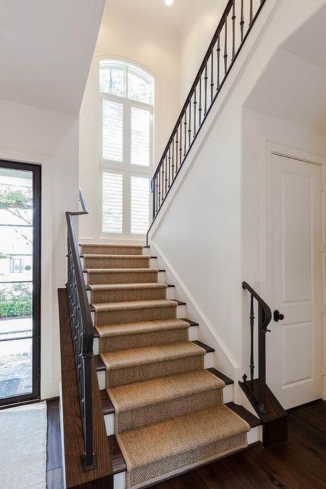 An iron and wood staircase is lined with a sisal stair runner stands next to a closet. Sisal Stair Runner, Decoration Hall, Staircase Runner, Traditional Staircase, Building Stairs, Entry Stairs, Staircase Remodel, Wood Staircase, Beige Wall