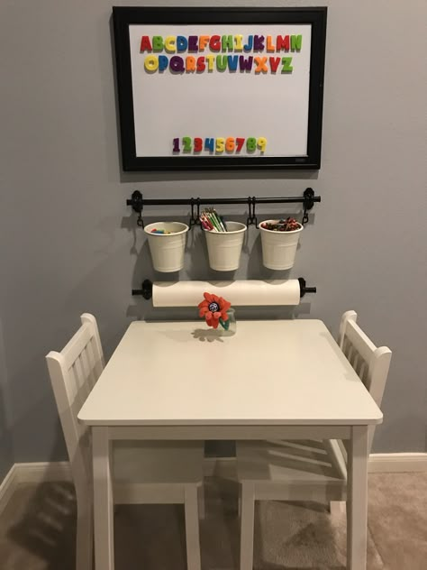 Great way to organize kids crafts! Metal organizer, paper and buckets from Ikea. Table and chairs from Home Depot. Kid Table Corner, Kids Art Caddy, Learning Playroom Ideas, Toddler Learning Area At Home, Kids Craft Table Organization, Homeschool Setup Ideas, Playroom Craft Table, Kids Art Center At Home, Kids Craft Corner Ideas