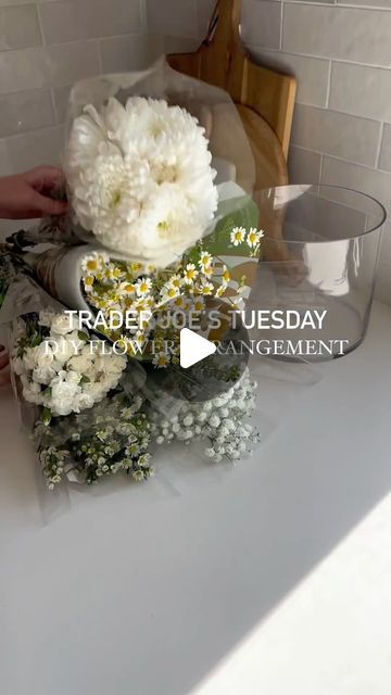 Amanda Hernandez on Instagram: "Large DIY flower arrangement for $28 💐  Trader Joe’s is my go to for flower arrangements. The prices are great and if you go early in the morning the selection is usually top notch!   For this arrangement I went with all white and greenery to give a very country feel. I made this for my 1980’s country goose themed ladies luncheon - so make sure you come back to see this arrangement used on my tablescape 🪿✨  #traderjoes #traderjoesflowers #flowerarrangement #diyflowers #tablescape #springvibes #explore" Shallow Dish Flower Arrangement, How To Build A Flower Arrangement, Trader Joes Flower Arrangements Diy, Trader Joe’s Diy Flowers, Trader Joe Flower Arrangement, Flower Arrangements Trader Joe’s, Trader Joes Bouquet Diy, How To Make Flower Arrangements, Trader Joes Flower Arrangements