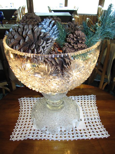 This is a great way to show off a punch bowl that you don't use very often...just fill it with Christmas light strands and decorate on top! Lynne Ludwig, the owner of The Rapids Lodge, put this one together. Punch Bowl Repurpose, Decorating With Crystal Bowls, Punch Bowls Ideas Repurpose, Glass Bowl Christmas Decorations, Repurposed Punch Bowl Ideas, Upcycle Punch Bowl, Punch Bowl Decorating Ideas, Christmas Tree Made From Crystal Bowls, Crystal Bowl Christmas Centerpiece