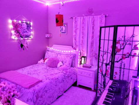 The image features many Japanese decorations. These including a lantern, partition, bedspread, cherry branches/vines, cherry blossom wallart, etc. The overall appeal is the cherry blossoms, which is indicated by the pink, black, white, and gray coloration. Neon Japanese Aesthetic Room, Japanese Theme Bedroom Ideas, Japanese Style Bedroom Aesthetic, Japan Themed Room, Japan Room Ideas, Japanese Teen Bedroom, Japan Room Aesthetic, Anime Themed Bedroom, Japanese Decor Bedroom