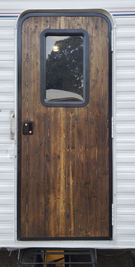 Rebuilt door from edge glued wood 1”x16”x72”. New window trim and door handle approx. $200.00 rebuild. Rustic Camper Renovation, Rv Door Ideas, Camper Door Ideas, Rv Door Trim Makeover, Rv Door Remodel, Exterior Camper Makeover, Wood Camper, Rustic Camper Makeover, Camper Exterior Makeover