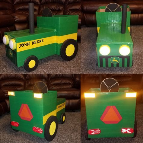 DIY 🚜 Handmade John Deere Tractor Costume made from cardboard boxes. Green & yellow duct tape to make it durable. Styrofoam tires, reflectors, laminated construction sign, push lights for headlights, laminated printed John Deere emblem. Cardboard grille & steering wheel. Tractor Costume, Cardboard Boxes Kids, Boys Halloween Costumes Diy, John Deere Birthday, Tractor Birthday Party, Cardboard Car, Farm Craft, Tractor Party, Farm Themed Birthday Party