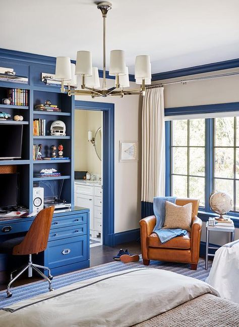 Blue and orange boys bedroom designed with a blue built-in desk and bookcase complementing blue moldings and a blue stripe rug. Boys Bedroom Orange, Boys Room Blue, Boys Room Design, Boy Bedroom Design, Built In Desk, Boy Bedroom, Big Boy Room, Family Room Design, Boys Bedrooms