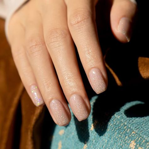 Not Just Nude Colors-The nude-toned color is littered with rainbow glitter that reflect and twinkle no matter where the light catches the nail. Nude nails always bring natural and pure beauty to all of ages and glitter gel nail polish is one of the most stylish ways to wear this trend. Soft sheer pink nude series colors. Use this shade of cream on its own or as an accent for your nail art. The nude-toned color is littered with rainbow glitter that reflect and twinkle no matter where the light ca Nude Shimmer Nails, Nails Shimmer, Nail Nude, Nude Nails With Glitter, Glitter Gel Nail Polish, Short Almond Nails, Uv Nail Lamp, Glitter Gel Polish, Nail Shimmer