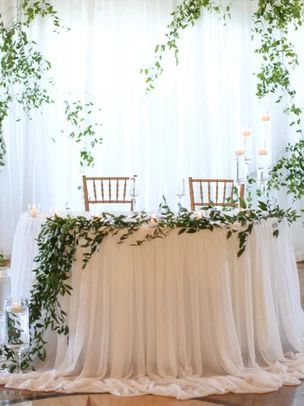 Bride And Groom Table Sage Green, How To Make Sweetheart Table Flowers, Simple White Sweetheart Table, Table For Newlyweds Wedding, Bridal Sweetheart Table, Wedding Groom And Bride Table Decoration, Grooms Table Decorations, Sweetheart Table Swag, White And Greenery Sweetheart Table