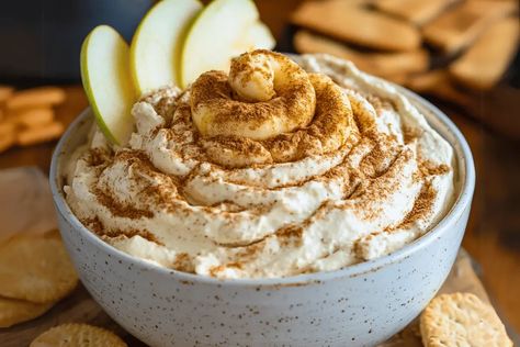 Make Cinnamon Roll Cheesecake Dip! A creamy, cinnamon-spiced dessert dip perfect for cookies, fruit, and holiday gatherings. Cinnamon Roll Dip, Cheesecake Dip Easy, Roll Cheesecake, Cookies Fruit, Cinnamon Roll Cheesecake, Dip Easy, Dessert Dip, Cheesecake Dip, Sweet Dips