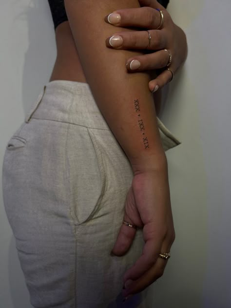 Roman Numeral Tattoo Arm, Roman Numeral Wrist Tattoo, Roman Numbers Tattoo, Basic Tattoos, Roman Numeral Tattoos, Small Pretty Tattoos, Writing Tattoos, Petite Tattoos, Forearm Tattoo Women