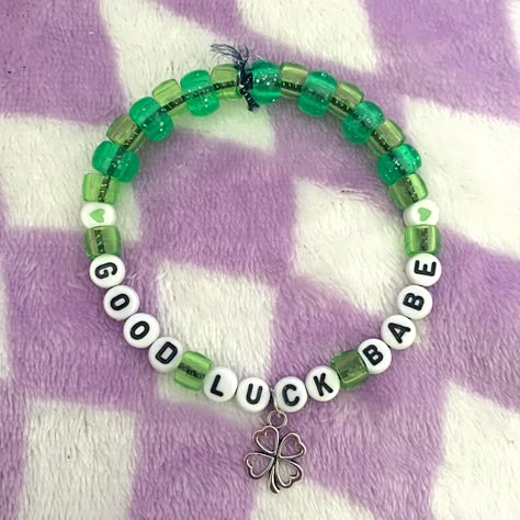 Chappell Roan inspired "Good Luck, Babe!" beaded friendship bracelet with alien charm. Inspired by the song "Good Luck, Babe!" by Chappell Roan. Bracelet is handmade with elastic, plastic pony beads, and a clover charm. Bracelet is apprx. 9" around.