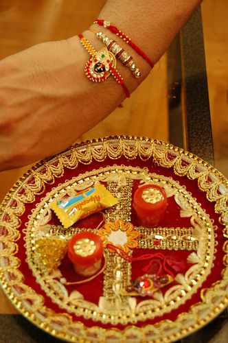 Rakhi    A Hindu tradition where a sister ties the jeweled string bracelets around the brothers wrist, praying for his health and prosperity. In return, the brother promises to take care of his sister, as a father would. Indian Holidays, Happy Raksha Bandhan Wishes, Images Of Faith, Raksha Bandhan Images, Puja Thali, Rakhi Special, Raksha Bandhan Wishes, Thali Decoration Ideas, Pooja Thali