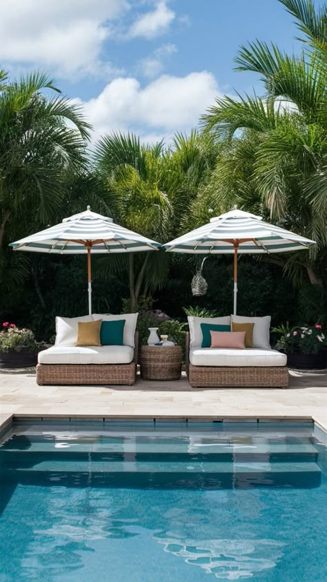 Check out these chic POOLSIDE FURNITURE IDEAS! This setup features a cozy OUTDOOR DAYBED and STRIPED UMBRELLAS, perfect for creating a relaxing YARD OASIS. With comfortable WICKER DAYBED seating and stylish cushions, you’ve got the ultimate lounging spot. Whether you're looking for COMFORTABLE OUTDOOR FURNITURE or some fresh POOL DECK PATIO IDEAS, this setup has you covered. Pool Lounge Furniture, Small Pool Lounge Area, Pool Deck Accessories, Luxury Pool Furniture, Pool Lounge Area Ideas, Pool Patio Furniture Layout, Pool Deck Seating Ideas, Pool Patio Furniture Ideas, Pool Deck Furniture Ideas