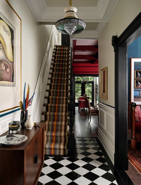 Tommy Smythe is known for his warm and personal mix of fine art, antique elements, and modern furnishings. His fun-loving approach to interiors results in spaces that are soulful, eclectic, and timeless. This entryway features checkerboard floors, a striped stair runner, and original architectural features. Book a 1:1 video consultation with Tommy Smythe on The Expert and get personalized interior design advice for your space. Toronto Couple, Entryway Shelves, Chocolate Brown Walls, Striped Stair Runner, Hall Ways, Checkered Floor, Toronto Interior Design, Small Guest Room, Red Dining Room