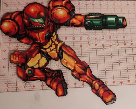 Samus from Metroid made with perler beads Samus Perler Beads, Metroid Samus Aran Art, Metroid Dread Samus, Snes Perler Beads, Super Metroid Snes, Metroid Samus, Perler Creations, Metroid, Perler Beads