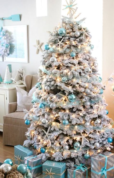 Snowy Flocked Coastal Christmas Tree Ideas with Blue Ornaments. Shop this Blue and White Coastal Christmas Look. Featured on Completely Coastal. Beach Home Christmas Decor, Boho Beach Christmas, Christmas Beach Aesthetic, Beach Christmas Tree Ideas, Modern Coastal Christmas Decor, Christmas Beach House, Christmas Aesthetic Summer, Coastal Christmas Aesthetic, Ocean Christmas Decor