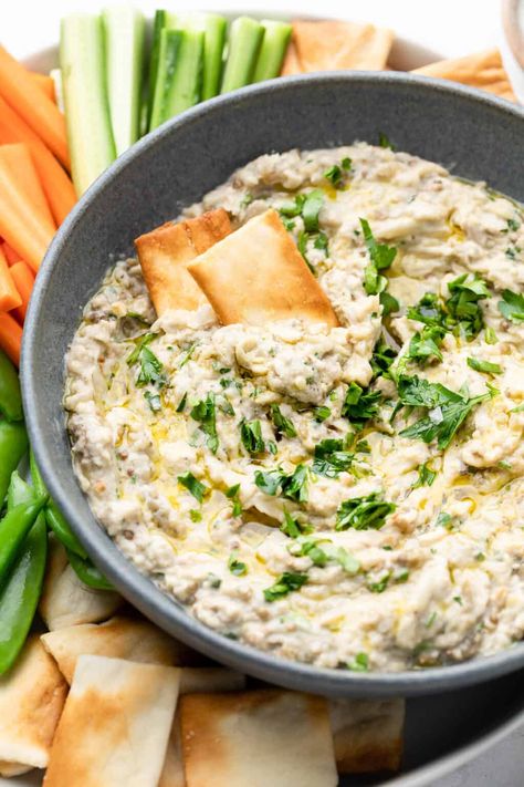 Who doesn't love a delicious dip? This roasted eggplant dip recipe is the perfect appetizer for any occasion. Made with tahini, garlic, fresh parsley, and a medley of seasonings, this eggplant dip has all the flavors you need to make your guests happy. Serve with veggies or crackers to enjoy while dinner is cooking. Perfect for weekly meal prep! Eggplant Dip Recipes, Erin Lives Whole, Whole Recipes, Roasted Eggplant Dip, Eggplant Dip, Veggie Snacks, Easy Gluten Free Recipes, Party Spread, Roasted Eggplant