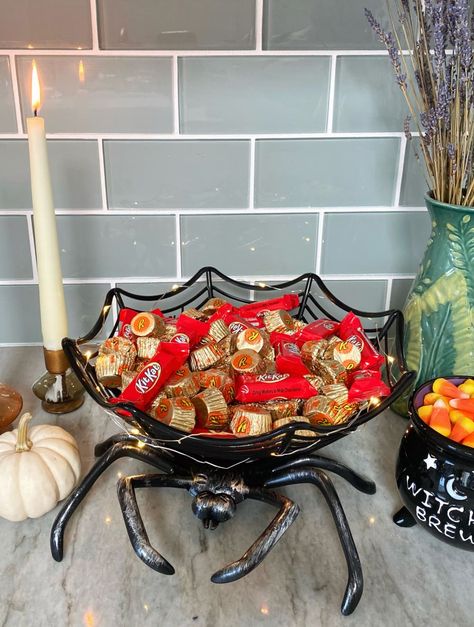 Spider web bowl filled with Halloween candy on kitchen counter. Halloween Candy Bowls Diy, Halloween Fruit Bowl, Halloween Candy Bowl On Porch, Halloween Serving Dishes, Halloween Bowl Decor, Dollar Tree Halloween Candy Bowl, Dollar Tree Spider Bowl, Diy Halloween Candy Bowl, Halloween Candy Bowl Ideas