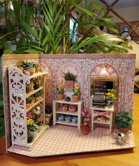 Welcome to my shop!  All the plants and furnishings I purchased from Etsy and Ebay but the interior design is mine!  I created this 1:12 scale flower shop for miniature enthusiasts who haven't the space for a doll's house!  Please note that this is not a toy...it is for decorative purposes only. Flower Shop Miniature, Flower Shop Diorama, Dollhouse Flower Boxes, Miniature House Diy, Dollhouse Miniatures Rooms, Popsicle Stick Houses, Room Box Miniatures, Fairy House Crafts, Miniature Bakery